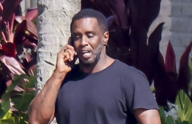 *PREMIUM-EXCLUSIVE* Sean 'Diddy' Combs appears downcast as he  relaxes by the water in Miami with  woman believed to be his longtime assisitant after settling the rape and abuse case with Cassie