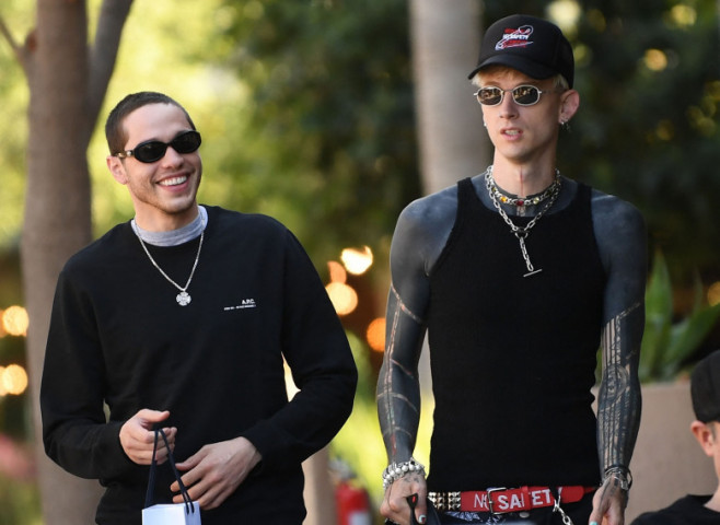 PREMIUM EXCLUSIVE: Machine Gun Kelly smokes a roll up cigarette as he and close pal Pete Davidson enjoy a bros day out in Los Angeles
