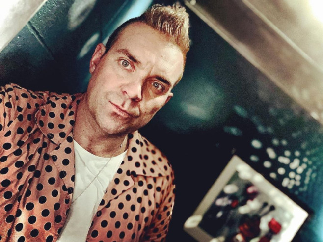 Robbie Williams lookalike booked up for next TWO YEARS after star's biopic hits silver screen