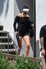 Hailey Bieber leaves the gym looking fit in form-fitting attire, complemented by a pop of color in her SKYLRK sandals