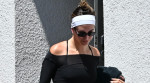Hailey Bieber leaves the gym looking fit in form-fitting attire, complemented by a pop of color in her SKYLRK sandals