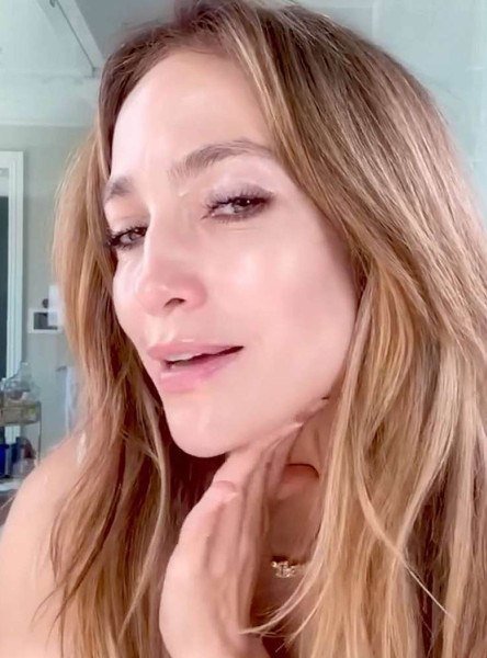 Jennifer Lopez went makeup-free  dancing to her own music and applying products from JLo Beauty to her face