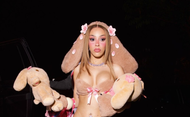 Doja Cat wears a bold plush bunny costume to her doll-themed birthday party