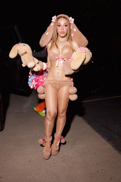 Doja Cat wears a bold plush bunny costume to her doll-themed birthday party