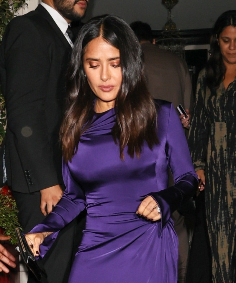 Salma Hayek Looks stunning wearing a purple dress arriving at David Beckham star studded after party for his Netflix film