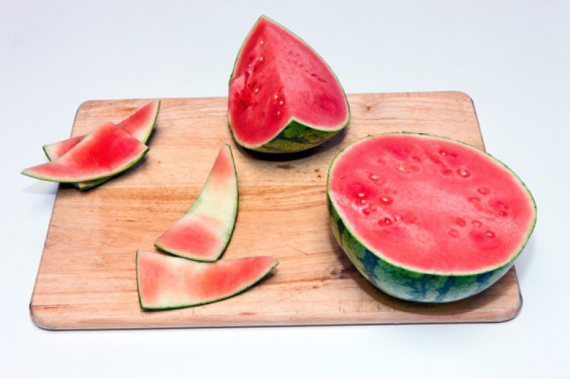 Slices of ripe watermelon on cutting board