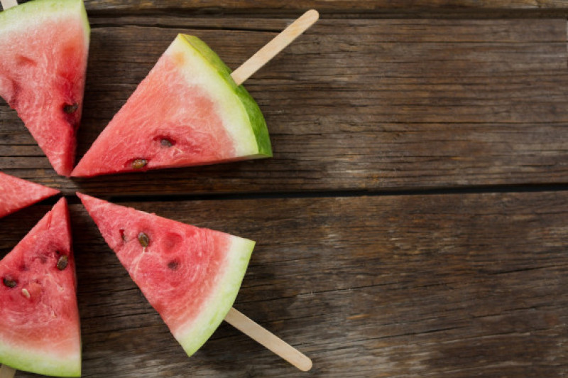 Slices of watermelon arranged on wooden table