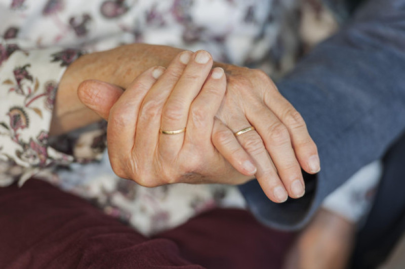 Hands of an 80 year old married couple