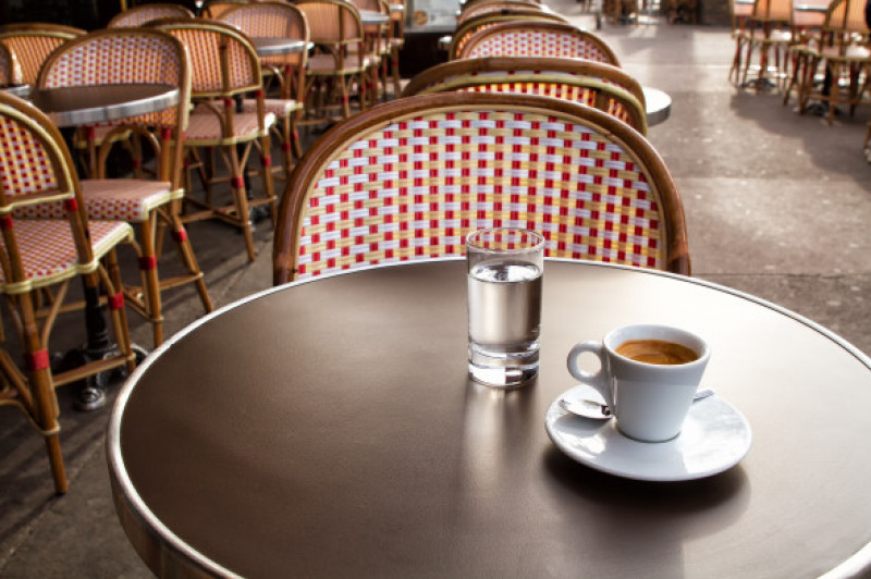Coffee and water on a table of parisian's bar