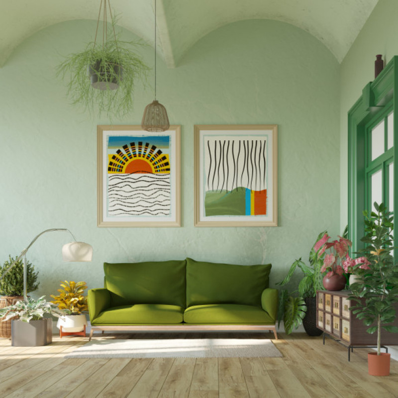 Stylish living room with green sofa and posters