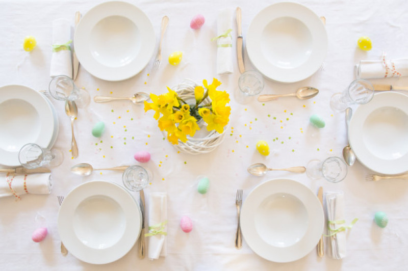 Laid Easter table with bunch of daffodils