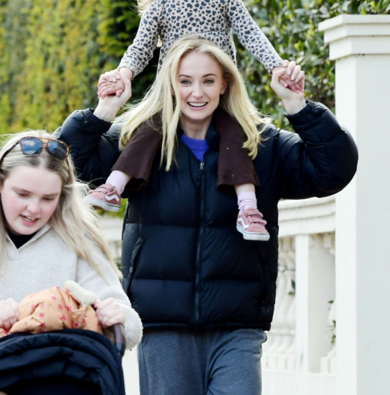 *PREMIUM-EXCLUSIVE* MUST CALL FOR PRICING BEFORE USAGE  - Game of Thrones English actress Sophie Turner rocks a large gold band as she looks in great mood as she's pictured having a great time with her daughter and friends in Sunny London.*PICTURES TAKEN