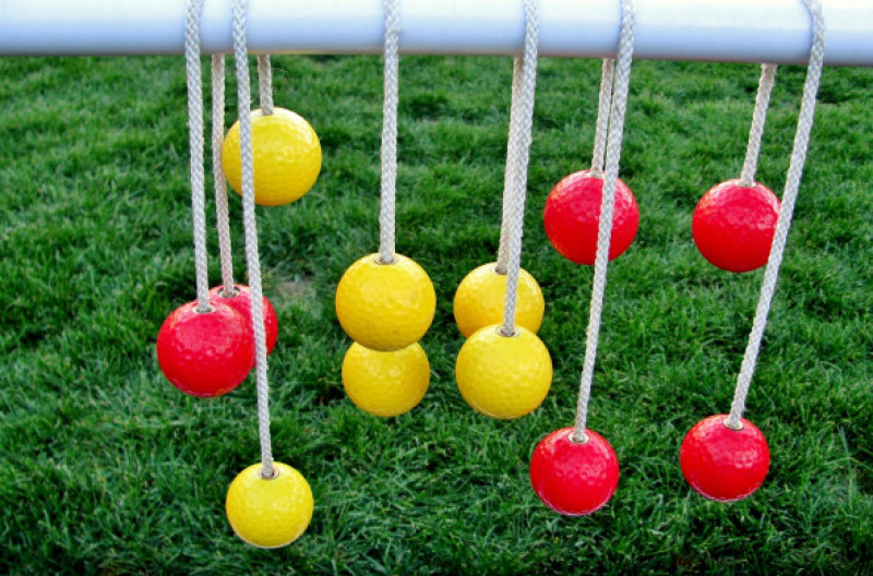 Yellow and red balls hanging on the ropes