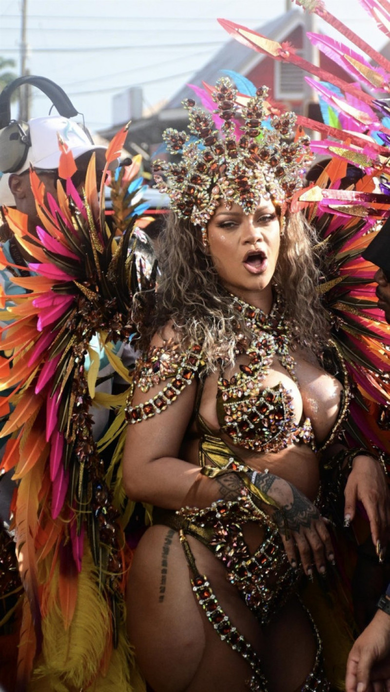 *EXCLUSIVE* Singer Rihanna Stuns at Carnival Festival In Barbados showcasing her 2024 outfit in a bejeweled bikini as she poses with police and fans