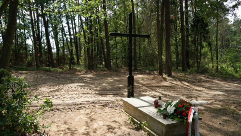 Mormânt simbolic în pădurea Bialucki, lângă locul unde a fost descoperită groapa comună. Sursa foto: Profimedia Images