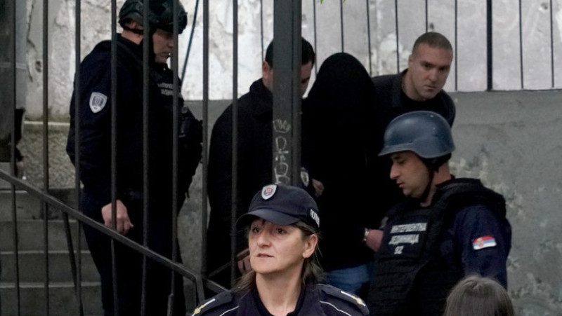 Elevul de 13 ani a fost încătușat și este escortat de poliție în afara școlii FOTO: Profimedia Images 