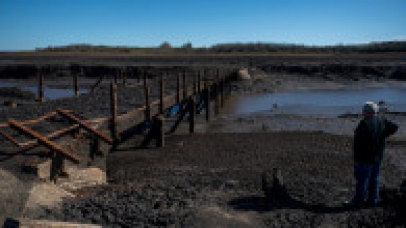 Uruguayan Raul Damiano looks at a bridge that emerged from under the Paso Severino reservoir amid a severe drought in Florida, Uruguay, on June 28, 2023. This reservoir, which normally supplies fresh water to 60 percent of the country