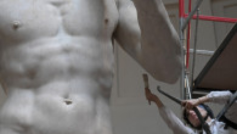 Restauratoarea italiană, Eleonora Pucci, curăță de praf statuia David a lui Michelangelo, la Galleria dell
