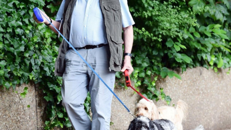 Robert Powell la pas prin Londra, împreună cu cei doi câini ai săi (2023). Foto: Profimedia