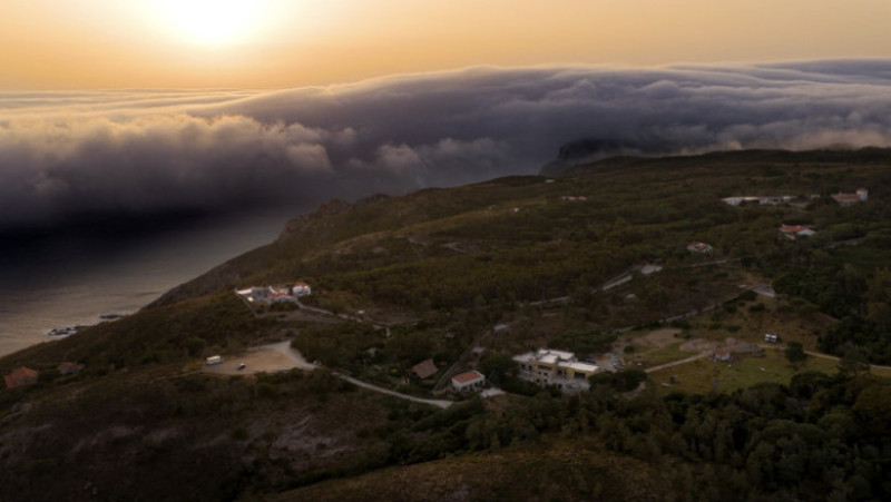 Fotografie realizată pe 29 iunie 2025 cu o dronă, care arată un rar „nor rulou”, un nor uriaș orizontal care avansează de la orizont spre plajele Oceanului Atlantic în timpul valului de căldură din apropierea Cabo da Roca, sud-vestul Portugaliei. Foto: Profimedia