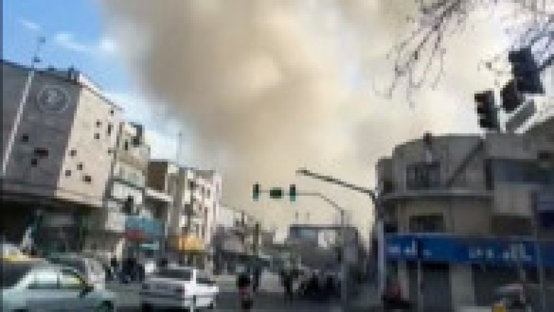 Această captură video preluată din imagini UGC postate pe rețelele sociale pe 28 februarie 2026 și verificată de echipele AFPTV din Paris arată o persoană mergând în timp ce un nor de fum se ridică în urma unei explozii raportate în Teheran. Foto: Profimedia | Poza 7 din 13