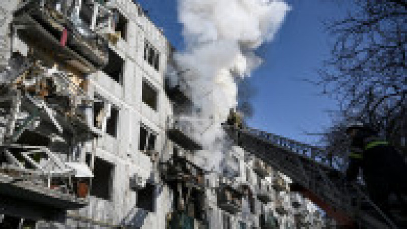 Firefighters work on a fire on a building after bombings on the eastern Ukraine town of Chuguiv on February 24, 2022, as Russian armed forces are trying to invade Ukraine from several directions, using rocket systems and helicopters to attack Ukrainian position in the south, the border guard service said. Russia