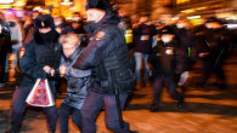Police officers detain a demonstrator during a protest against Russia