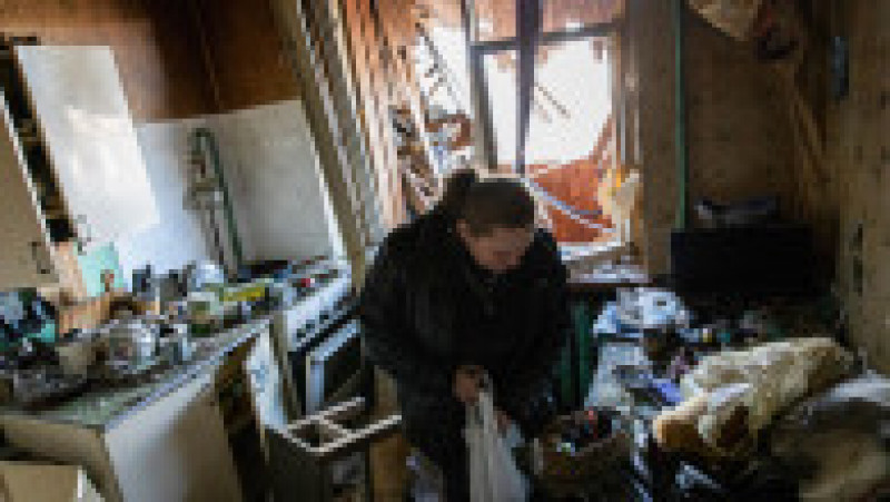 O femeie încearcă să recupereze bunuri din apartamentul său distrus de bombele rusești. Foto: Profimedia Images | Poza 4 din 11