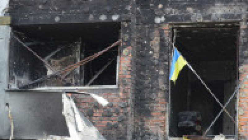 Un steag ucrainean rezistă în fața unei clădiri distruse în Mariupol. Foto: Profimedia Images | Poza 1 din 13