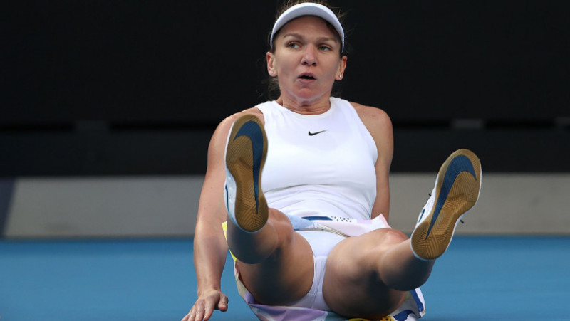 MELBOURNE, AUSTRALIA - JANUARY 21: Simona Halep of Romania falls over during her Women's Singles first round match against Jennifer Brady of the United States on day two of the 2020 Australian Open at Melbourne Park on January 21, 2020 in Melbourne, Australia. (Photo by Clive Brunskill/Getty Images)