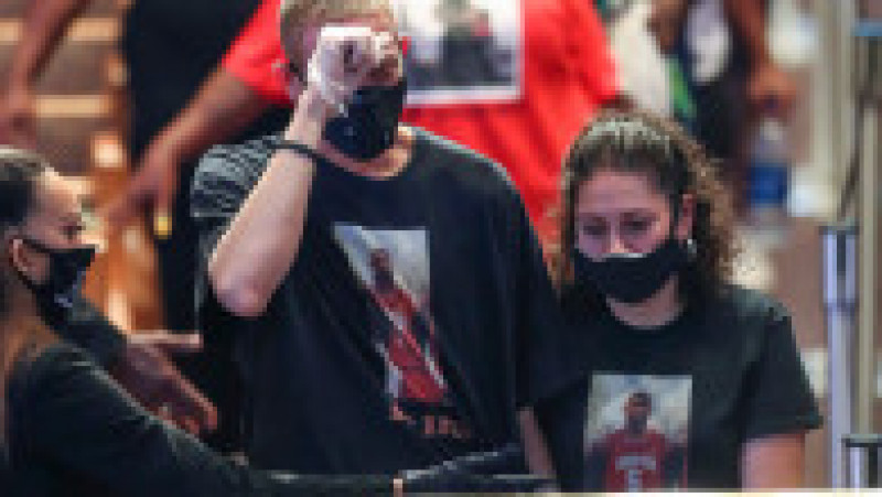 A man wearing a t-shirt with an image of George Floyd as a Yates High School basketball player reacts as he views the casket of Floyd during a public viewing, June 8, 2020, at The Fountain of Praise church in Houston. Floyd died after being restrained by Minneapolis Police officers on May 25.,Image: 529083738, License: Rights-managed, Restrictions: , Model Release: no | Poza 4 din 4