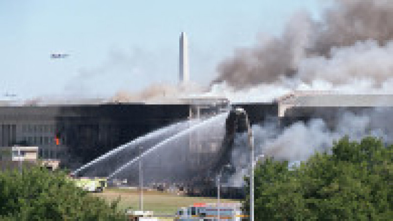 394276 02: The Washington Momument stands in the background as firefighters pour water on a fire at the Pentagon that was caused by a hijacked plane crashing into the building September 11, 2001 in Washington, DC. (Photo by Greg Whitesell/Getty Images) | Poza 17 din 19