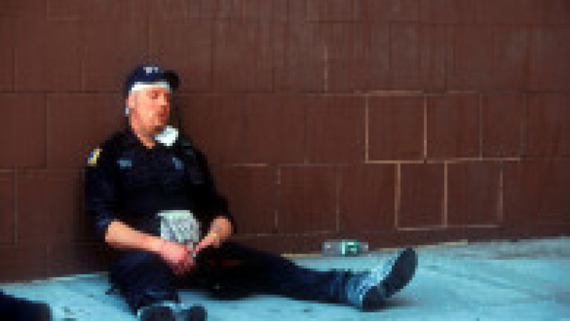394273 12: An emergency worker takes a break from the rescue effort after the World Trade Center