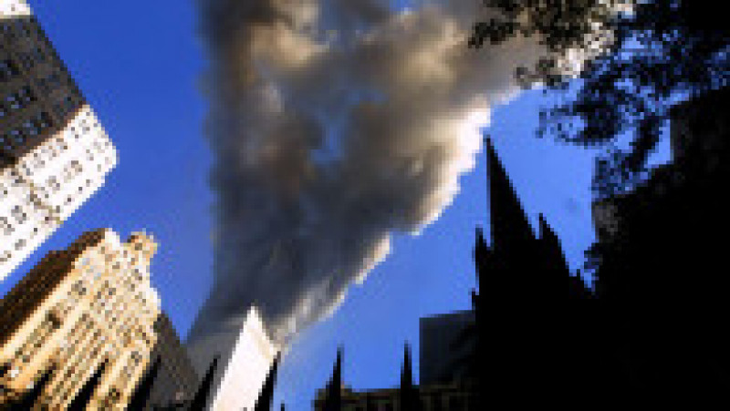 394261 77: Smoke spews from a tower of the World Trade Center September 11, 2001 after two hijacked airplanes hit the twin towers in an alleged terrorist attack on New York City. (Photo by Mario Tama/Getty Images) | Poza 1 din 19