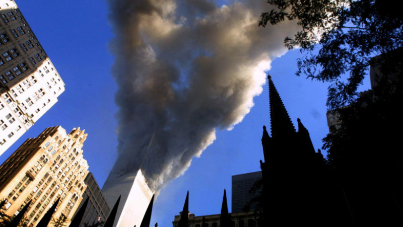 394261 77: Smoke spews from a tower of the World Trade Center September 11, 2001 after two hijacked airplanes hit the twin towers in an alleged terrorist attack on New York City. (Photo by Mario Tama/Getty Images)