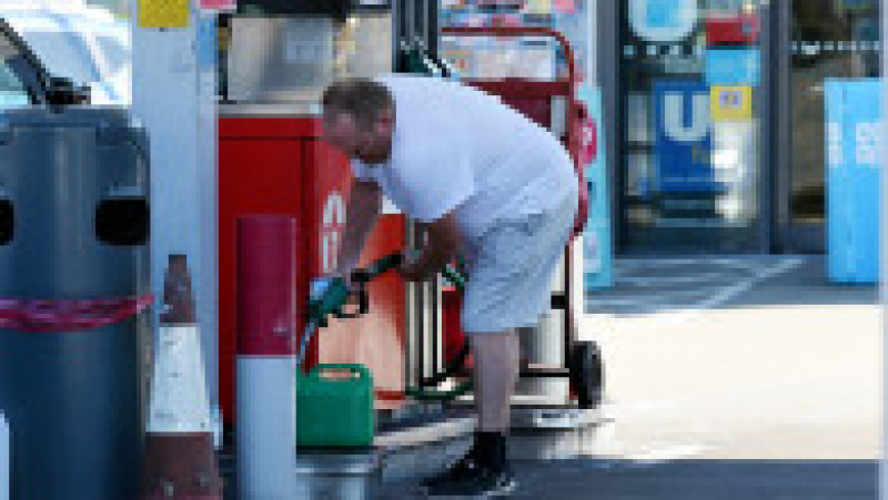 Un bărbat umple o canistră de benzină la o staţie din Marea Britanie, afectată de o criză de carburanţi. Foto: Profimedia Images | Poza 6 din 8
