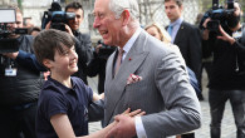 BUCHAREST, ROMANIA - MARCH 31: Prince Charles, Prince of Wales receives a hug from Valentin Blacker, son of William Blacker who is a local conservationist during a walking tour of the Old Town on the third day of his nine day European tour on March 31, 2017 in Bucharest, Romania. The Monuments Ambulance is a pilot restoration project supported by William Blacker. (Photo by Chris Jackson - WPA Pool/Getty Images) | Poza 4 din 8