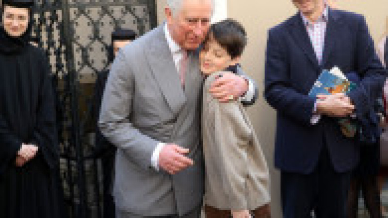 BUCHAREST, ROMANIA - MARCH 31: Prince Charles, Prince of Wales hugs Valentin Blacker, son of William Blacker (R) who is a local conservationist during a walking tour of the Old Town on the third day of his nine day European tour on March 31, 2017 in Bucharest, Romania. The Monuments Ambulance is a pilot restoration project supported by William Blacker. (Photo by Chris Jackson - WPA Pool/Getty Images) | Poza 5 din 8