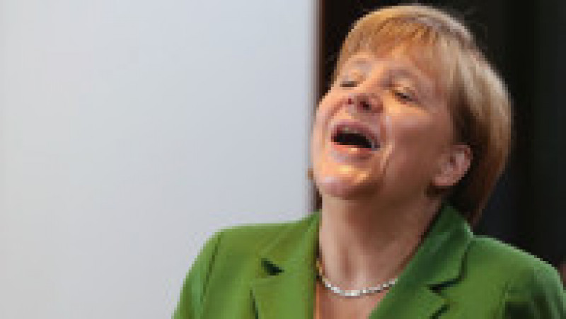 BERLIN, GERMANY - NOVEMBER 28: German Chancellor Angela Merkel laughs at a colleagues comment as she arrive for the wekkly German government cabinet meeting on November 28, 2012 in Berlin, Germany. High on the morning
