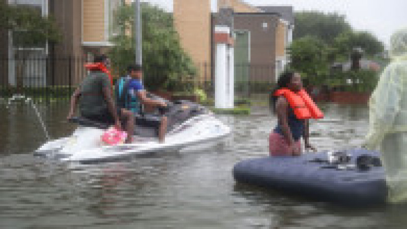 HOUSTON, TX - AUGUST 27: A Jetski is used to help people evacuate homes after the area was inundated with flooding from Hurricane Harvey on August 27, 2017 in Houston, Texas. Harvey, which made landfall north of Corpus Christi late Friday evening, is expected to dump upwards to 40 inches of rain in Texas over the next couple of days. (Photo by Joe Raedle/Getty Images) | Poza 14 din 15