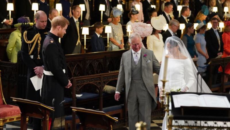 WINDSOR, UNITED KINGDOM - MAY 19: Prince Harry looks at his bride, Meghan Markle, as she arrives accompanied by Prince Charles, Prince of Wales during their wedding in St George's Chapel at Windsor Castle on May 19, 2018 in Windsor, England. (Photo by Jonathan Brady - WPA Pool/Getty Images)