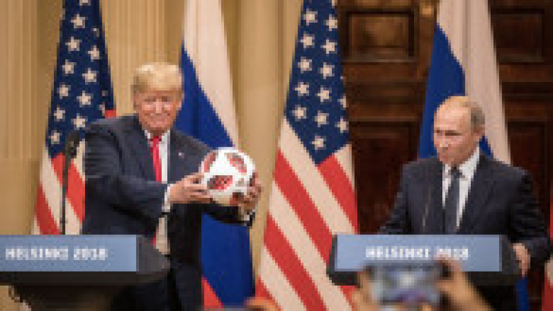 HELSINKI, FINLAND - JULY 16: U.S. President Donald Trump (L) poses with a football given to him by Russian President Vladimir Putin during a joint press conference after their summit on July 16, 2018 in Helsinki, Finland. The two leaders met one-on-one and discussed a range of issues including the 2016 U.S Election collusion. (Photo by Chris McGrath/Getty Images) | Poza 9 din 9