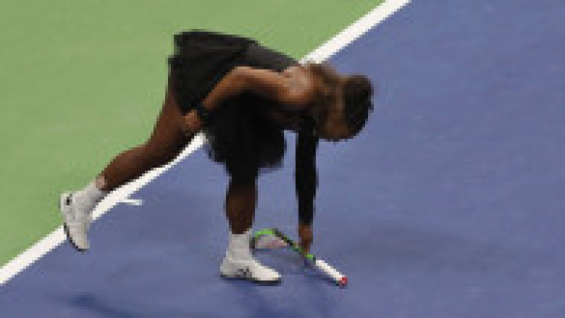 NEW YORK, NY - SEPTEMBER 08: Serena Williams of the United States picks up her smashed racket during her Women