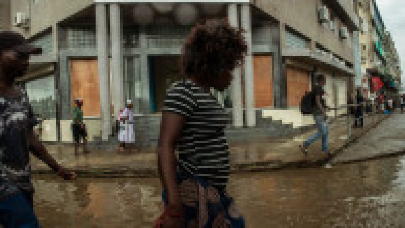 BEIRA, MOZAMBIQUE - MARCH 22: People walk is the standing water in a street on March 22, 2019 in downtown Beira, Mozambique. Thousands of people are still stranded after after Cyclone Idai hit the country last week. (Photo by Andrew Renneisen/Getty Images) | Poza 3 din 7