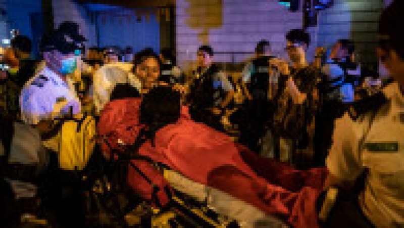 HONG KONG, HONG KONG - JUNE 10: A protester is taken away after being injured during a clash at Legislative Council after a rally against the extradition law proposal at the Central Government Complex on June 10, 2019 in Hong Kong China. Over a million protesters marched in Hong Kong on Sunday against a controversial extradition bill that would allow suspected criminals to be sent to mainland China for trial as tensions escalated in recent weeks.(Photo by Anthony Kwan/Getty Images) | Poza 9 din 15