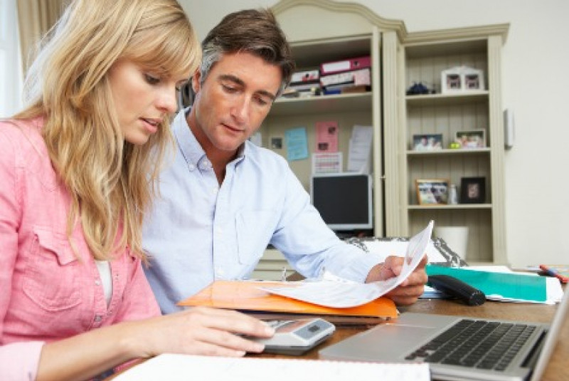Couple Looking At Finances In Home Office Together