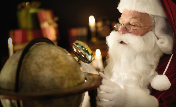 Santa Claus looking through magnifying glass at globe