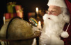 Santa Claus looking through magnifying glass at globe