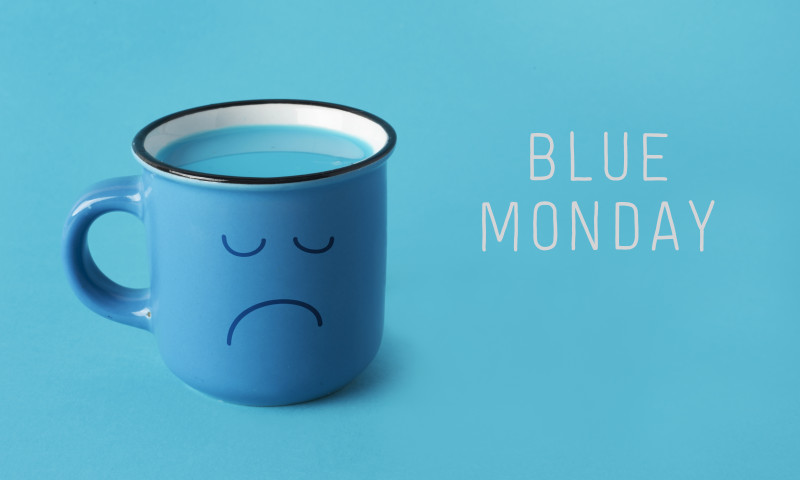 blue mug with sad face and text blue monday